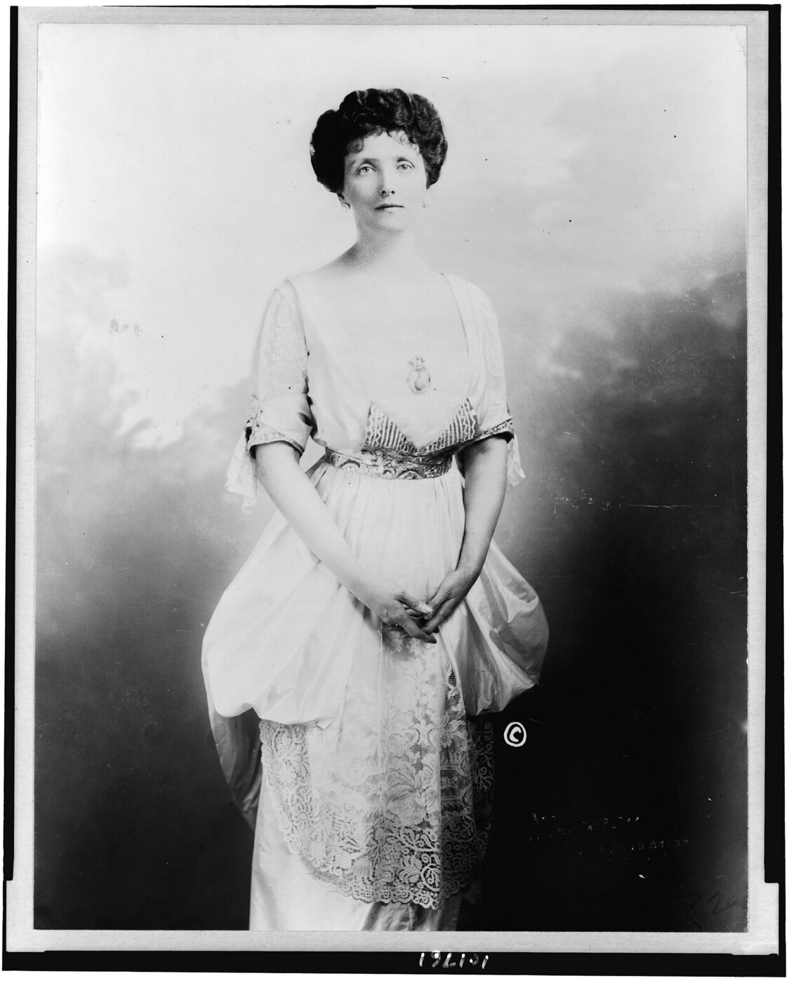 Studio portrait of Emily Post in a dark dress, facing the camera.