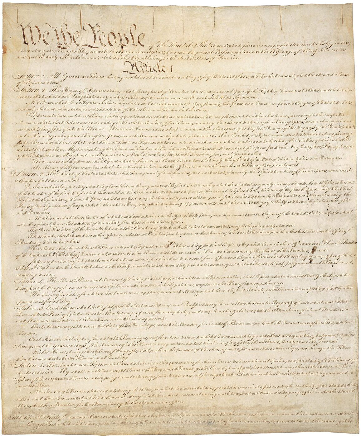 A large sheet of aged parchment covered in dense eighteenth-century handwriting, headed with the words We the People in ornamental script and continuing through Article I, Sections 1 to 7.