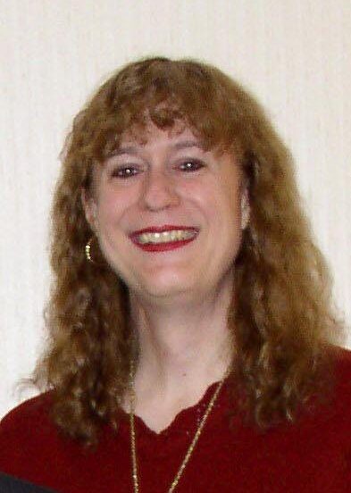 A portrait photograph of Mary Ann Horton, a Usenet and Unix pioneer, smiling towards the camera.