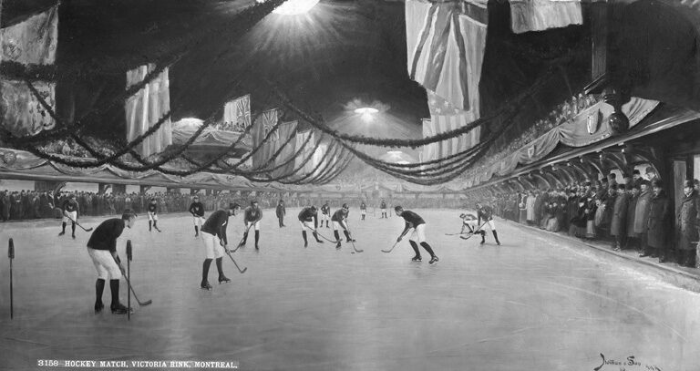 Black and white composite photograph of an indoor skating rink hung with flags and bunting, with hockey players in dark and light jerseys posed across the ice and spectators watching from both sides.
