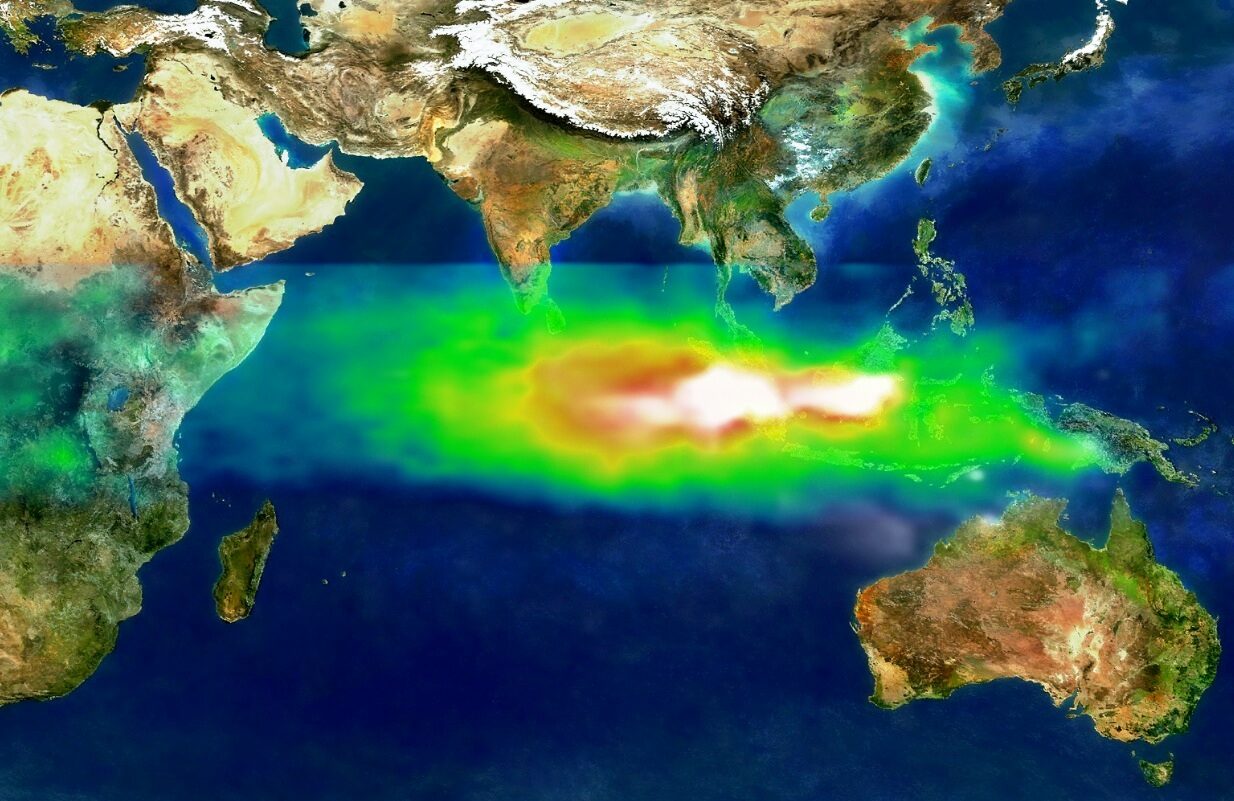 Satellite data map of maritime Southeast Asia and the Indian Ocean with a broad plume running west from Borneo and Sumatra, white at its core and shading through red, yellow and green at its edges.