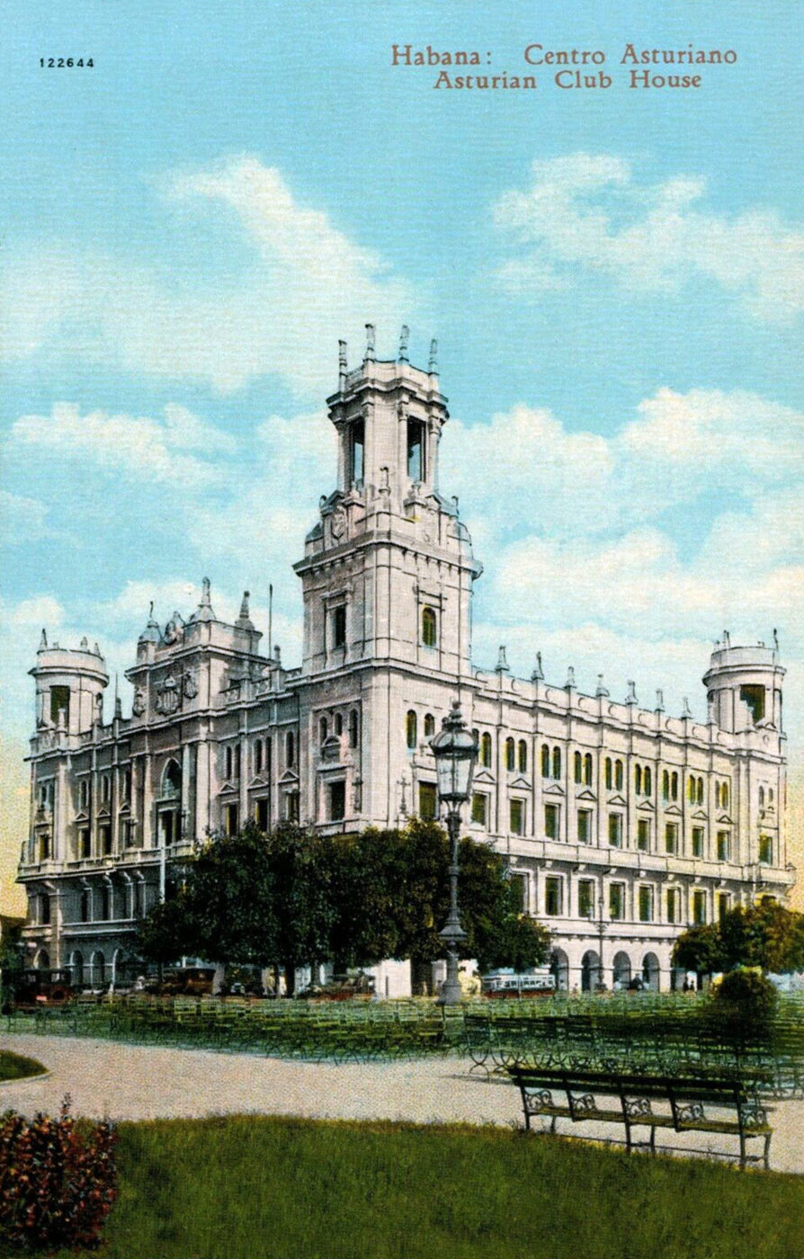 Tinted postcard of a large ornate pale stone palace of four storeys with a tall square corner tower topped with pinnacles. The caption Habana: Centro Asturiano, Asturian Club House is printed across the sky; trees, park benches and a tram stand in front.