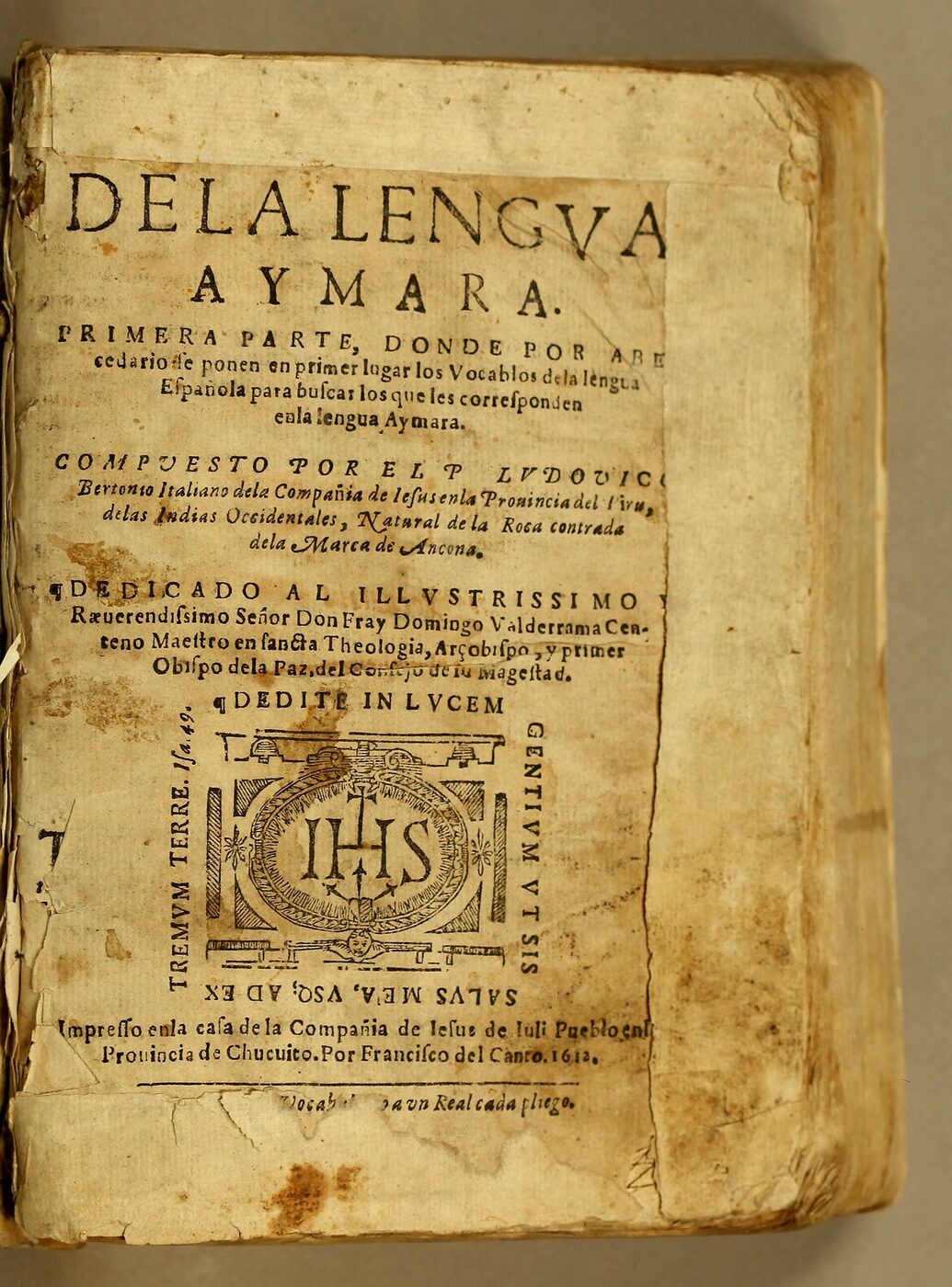 Worn and stained title page of an early seventeenth-century printed book, headed DE LA LENGVA AYMARA in large capitals, with a Jesuit IHS device below the text and an imprint line naming Juli in the province of Chucuito and the printer Francisco del Canto, 1612.
