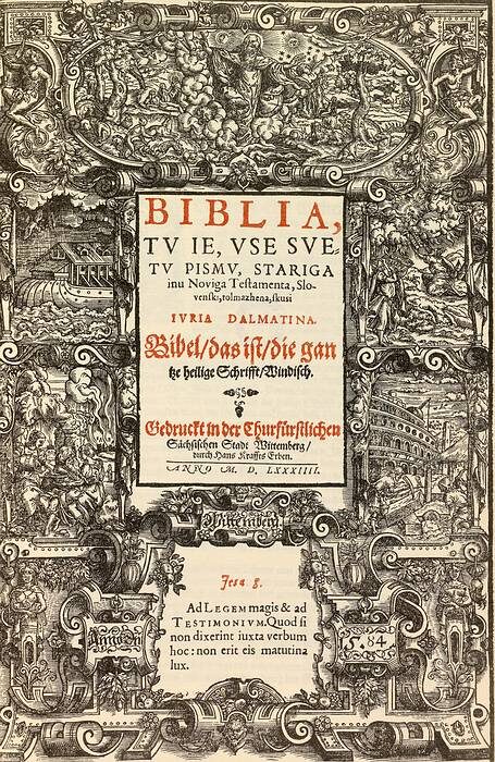 An engraved sixteenth-century book title page with a dense decorative border of figures and scenes framing a central panel of red and black letterpress type.
